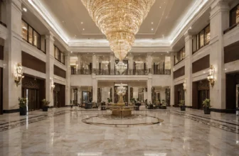 Polished stone hotel lobby with a custom chandelier in Dubai